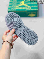 Close-up of the patterned rubber outsole with circular and grid traction details.