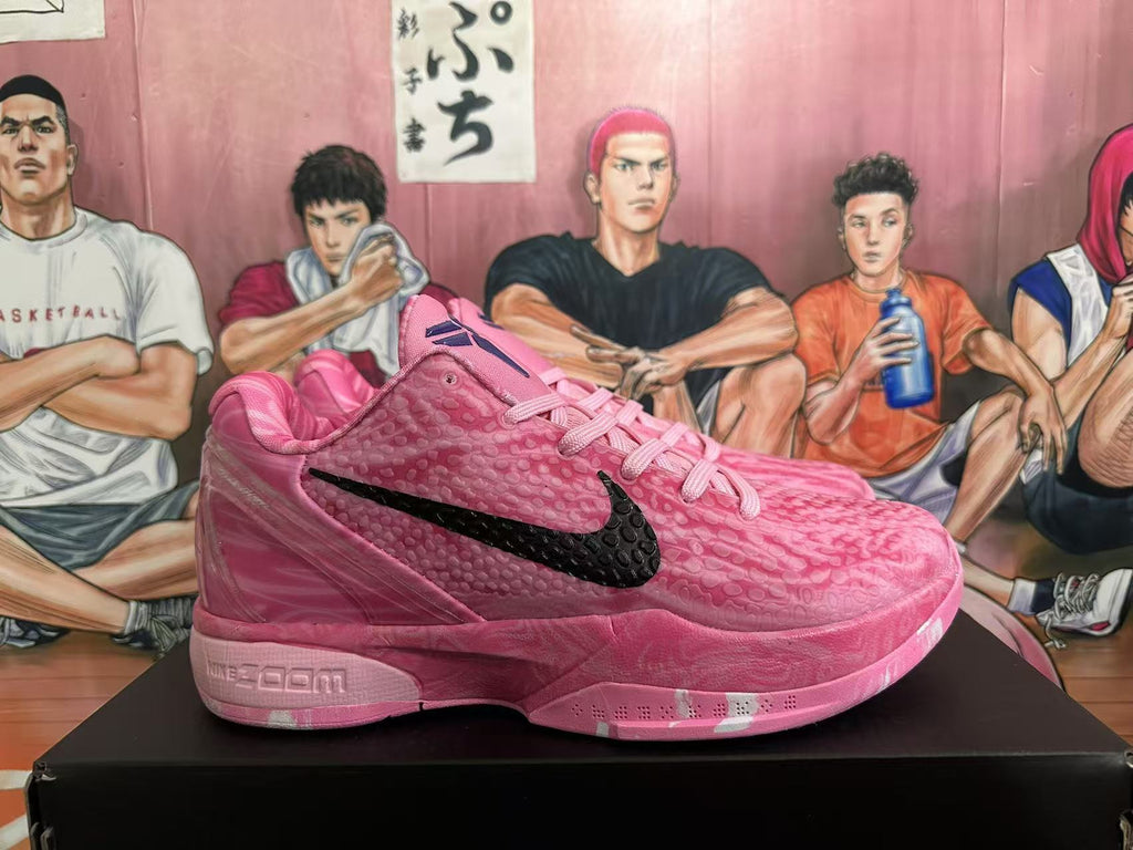 Side profile of a pink basketball sneaker showing the black swoosh, textured upper, layered sole, and Nike Zoom heel branding.