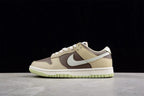 Opposite side profile showing the beige and brown upper, contrasting Swoosh, white midsole, and light green outsole.
