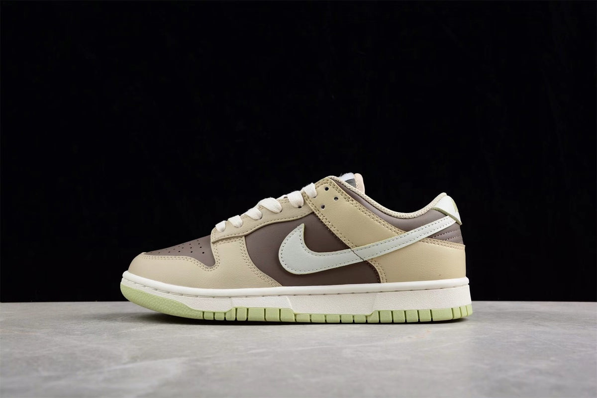 Opposite side profile showing the beige and brown upper, contrasting Swoosh, white midsole, and light green outsole.