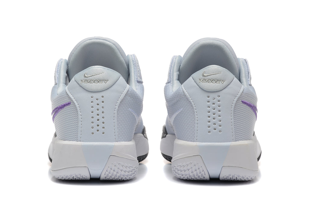 Rear view of pale grey Nike shoes with purple side accents and perforated heel panels
