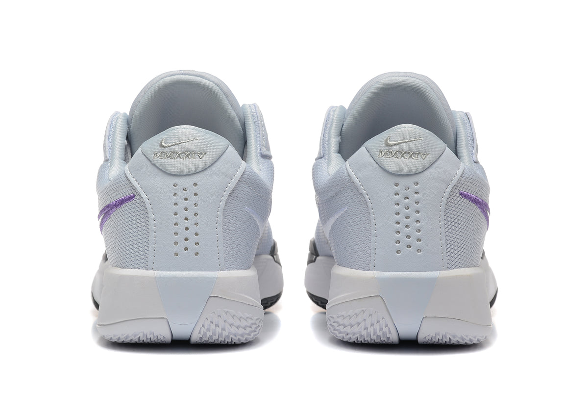 Rear view of pale grey Nike shoes with purple side accents and perforated heel panels