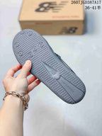 Close view of the textured gray outsole with circular grip details and New Balance branding.