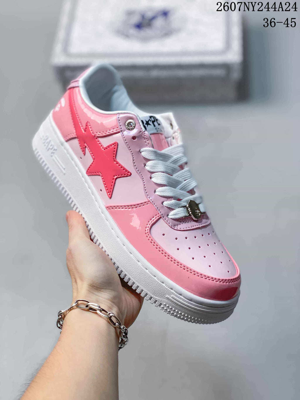 Pink and white low-top sneaker with pink star graphic, white laces and white sole; source overlay shows style code 2607NY244A24 and size range 36–45.
