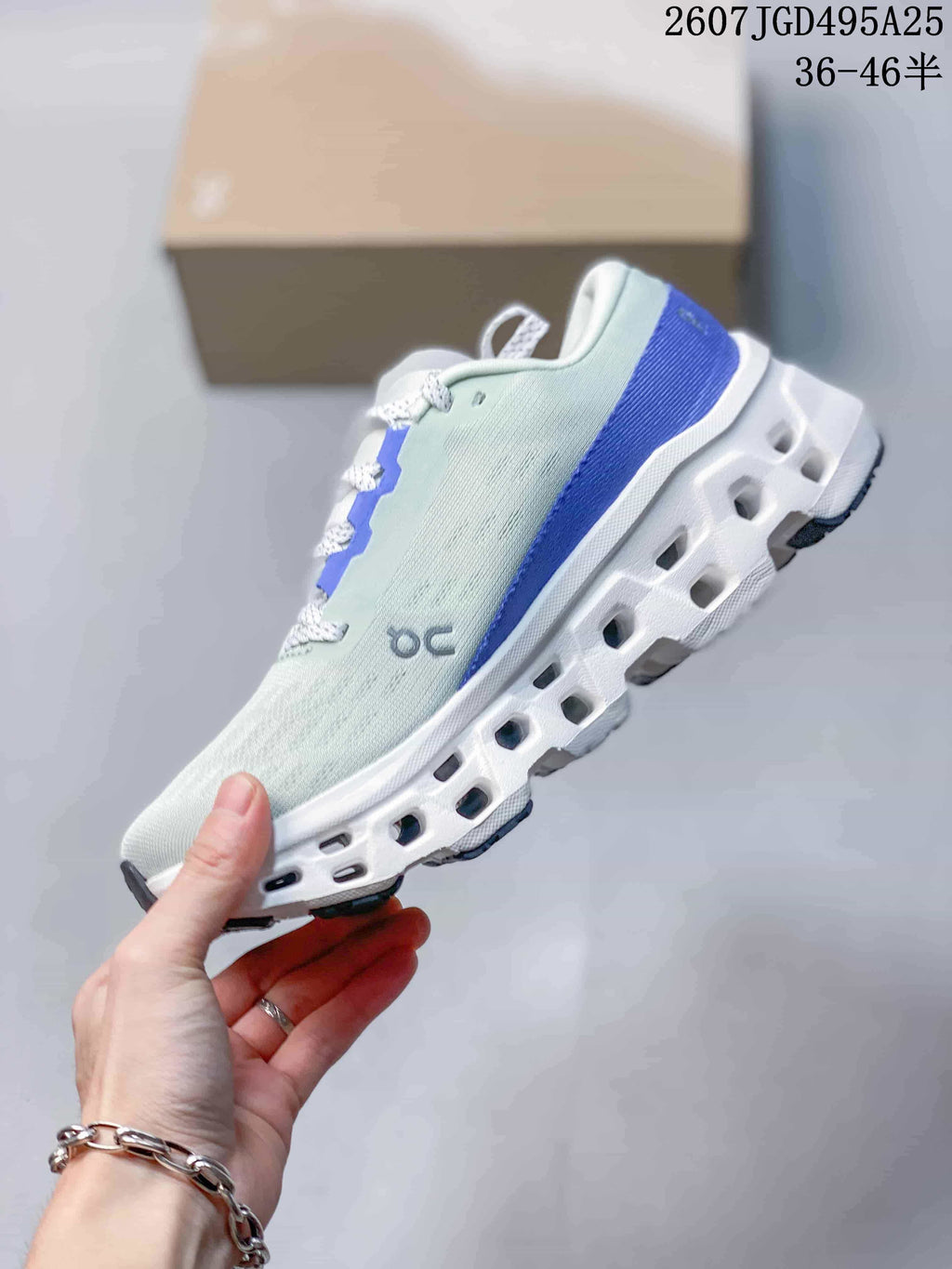 Side view showing the light green upper, blue heel accent and open-channel sole