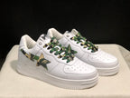 Three-quarter front view of the pair highlighting the white uppers, camouflage side panels, and textured soles.