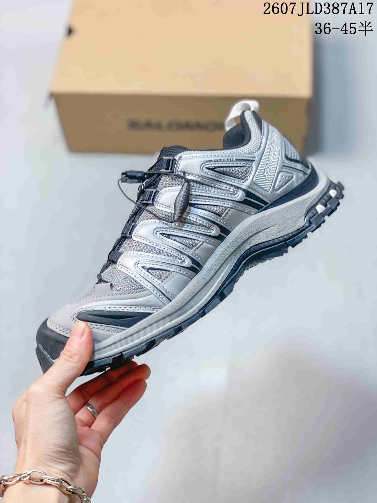 Side profile of the silver and black Salomon XA Pro 3D sneaker showing the structured upper, quick-lace system, and layered sole.