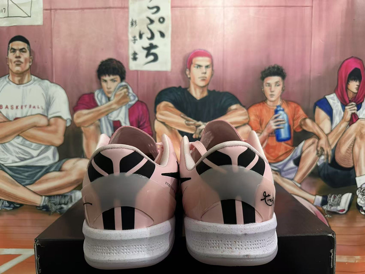 Rear view of pink Nike sneakers showing black heel details and white textured soles.