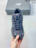 Top view of the dark gray New Balance 509 sneaker showing the mesh tongue, flat laces, toe box, and layered upper.