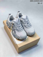 Pair of gray ASICS GEL-NYC RGD sneakers displayed on a shoebox, with the size range 36–47 visible in the upper right.