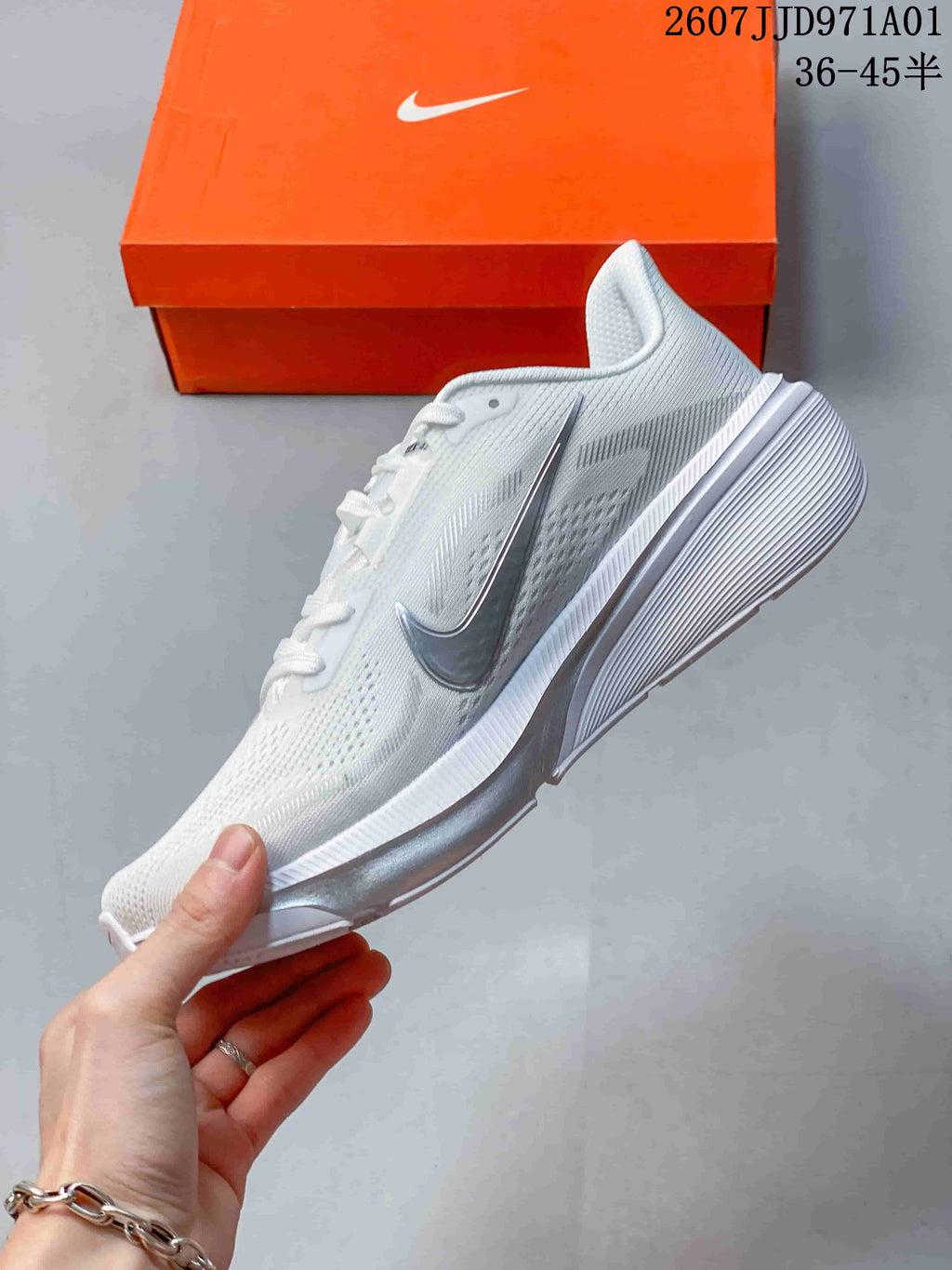Side profile of the white running shoe with silver-toned accents