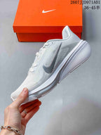 Side profile of the white running shoe with silver-toned accents