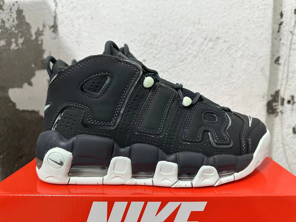 Side view showing oversized AIR lettering, black panels, pale mint-green lace details, and visible cushioning units.