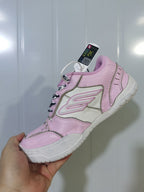 Close-up view of the pink and white sneaker showing the side branding, stitched panels, padded collar, and textured outsole.