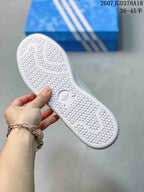 Close view of the textured white outsole with adidas branding and a patterned tread.