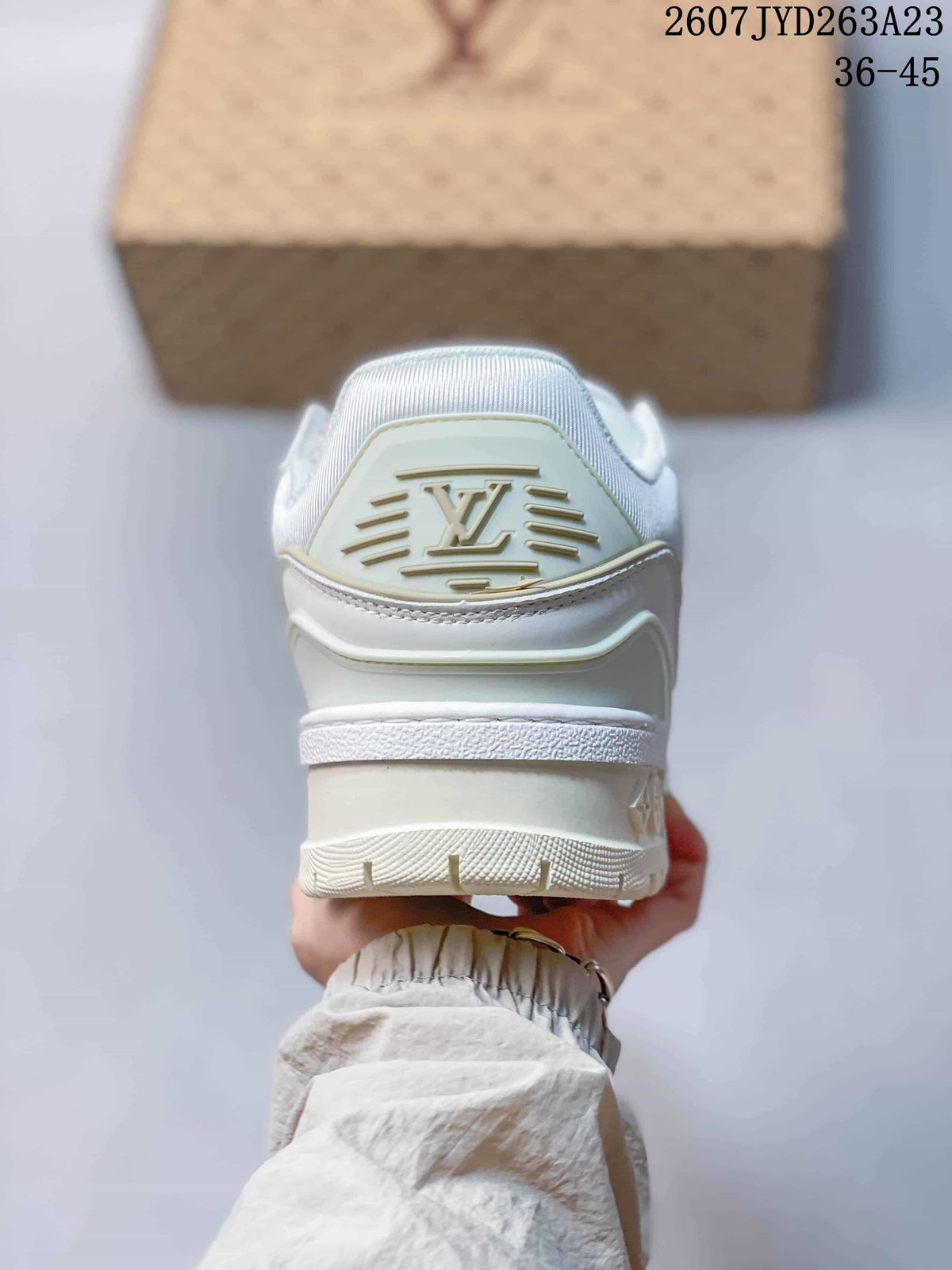 Rear view of a white Louis Vuitton sneaker showing the raised logo panel, padded collar and layered heel construction; image text shows code 2607JYD263A23 and size range 36–45.