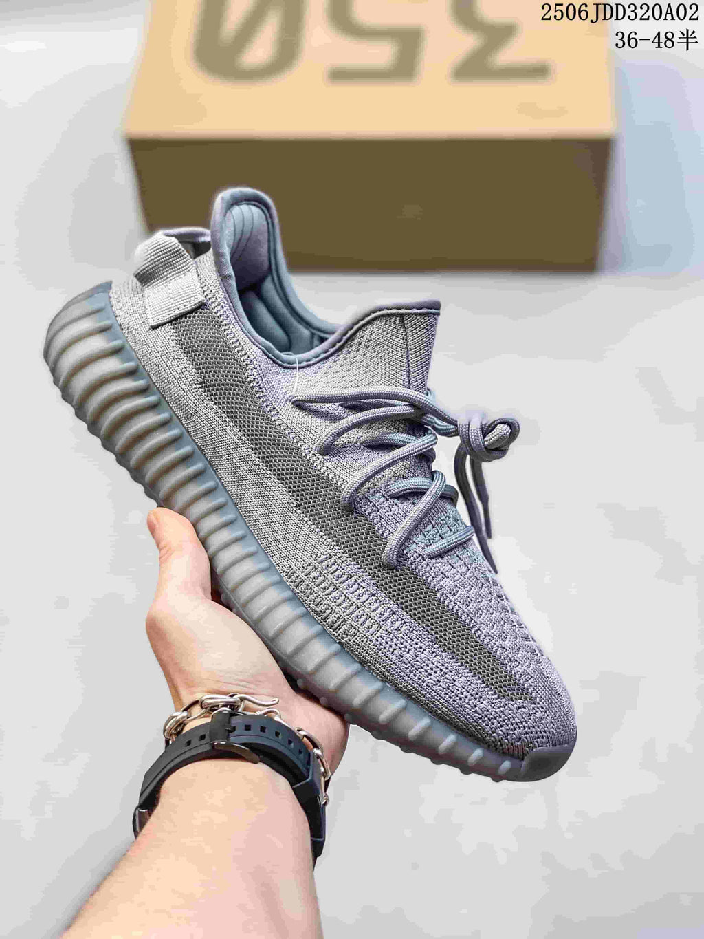 Gray Adidas Yeezy-style sneaker with a textured upper, tonal side stripe and ridged sole.