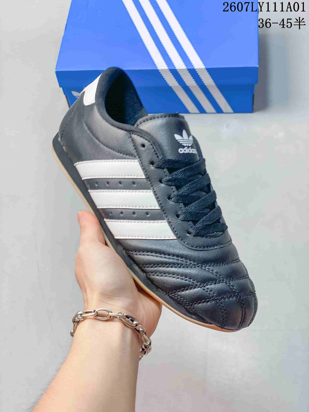 Angled view of the sneaker showing its white side stripes and quilted toe