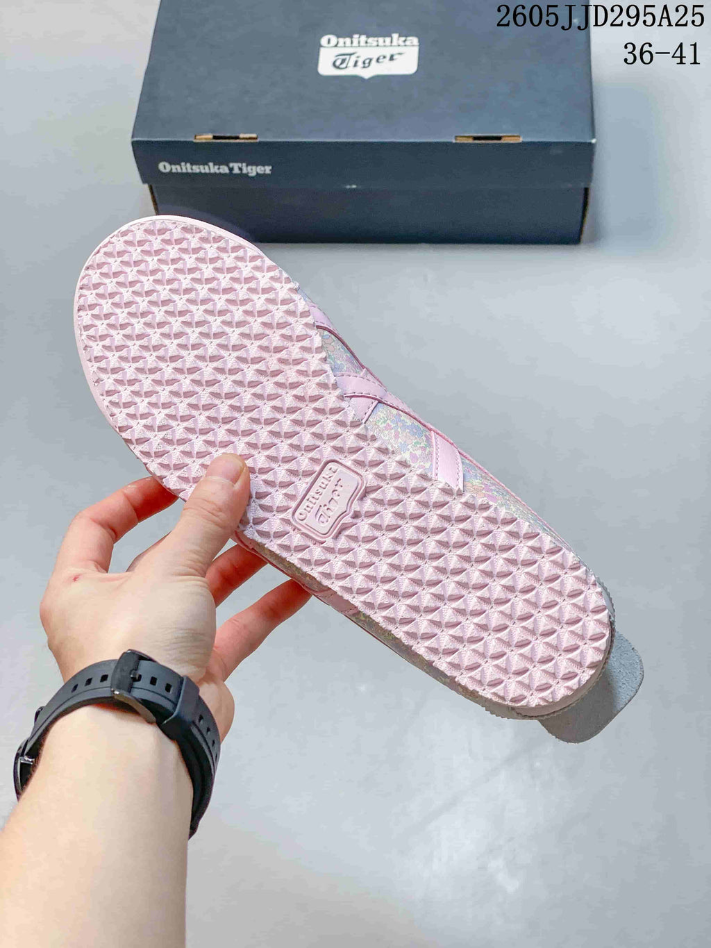 Close view of the patterned rubber outsole and Onitsuka Tiger shoebox.