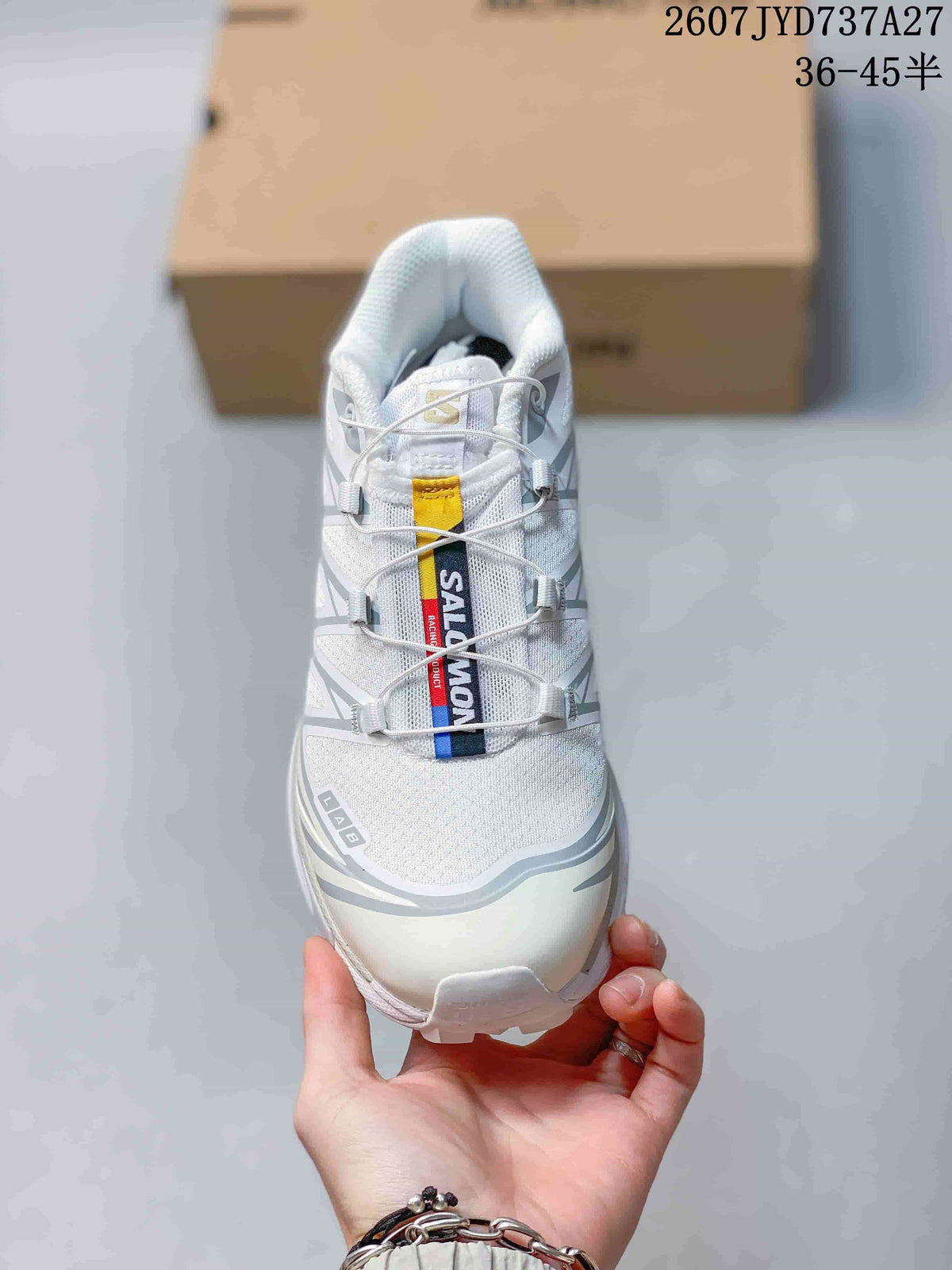 Front view showing the white and gray upper, contrasting tongue label, cord-style lacing, and rounded toe.