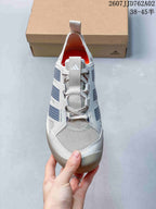Front view showing the mesh-look toe, laces, and orange lining.