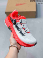 Close-up of a white and red Altra TIMP 5 BOA trail running shoe with a BOA dial and contrasting outsole.