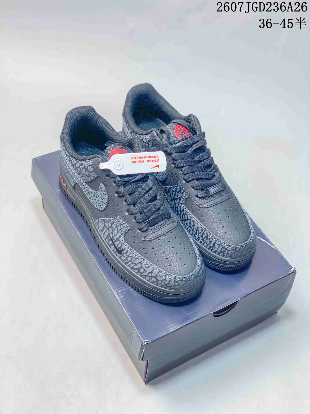 Pair of dark gray low-top sneakers shown on a shoebox, with patterned overlays, red accents, and a visible source size range marking.