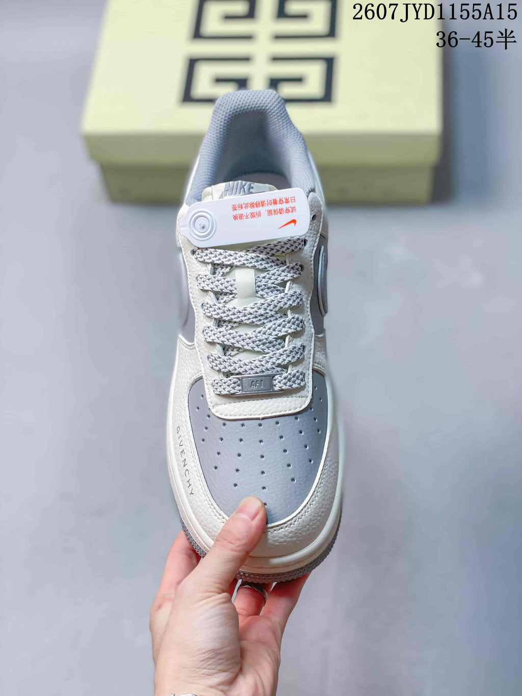 Top view of the sneaker showing the braided laces, perforated gray toe box, tongue branding, and contrasting panels.