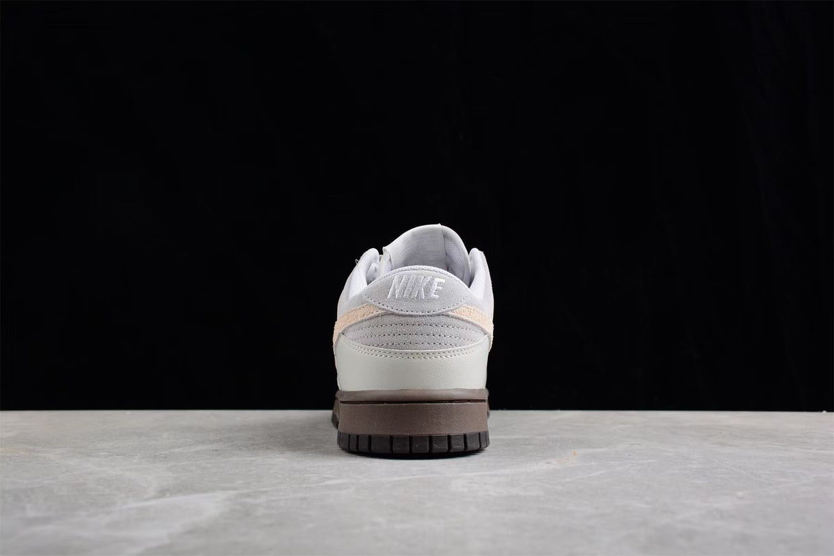 Rear view showing the padded heel collars, Nike heel branding and contrasting beige heel detail.