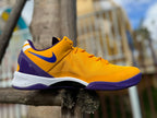 Side view of a gold and purple Nike Kobe 8 basketball shoe