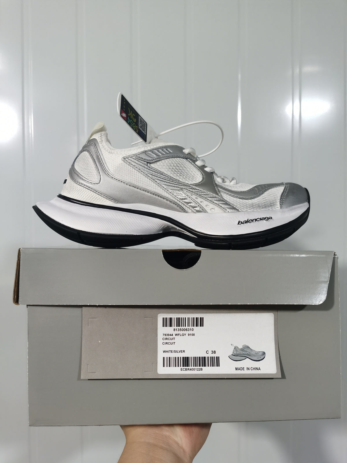 White and silver Balenciaga Circuit sneaker shown above its box; the box label identifies Circuit, style code 9100, color White/Silver, and size C 38.