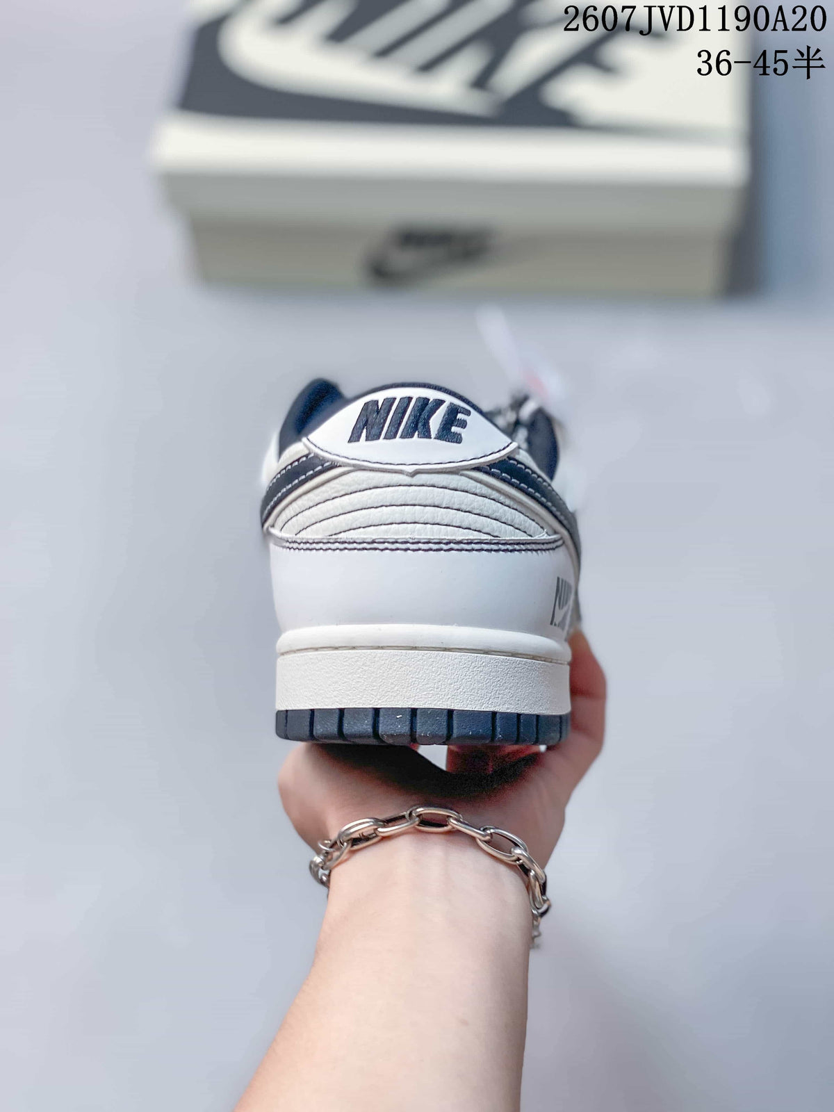 Rear view showing the padded heel, Nike branding, layered stitching, and dark outsole edge.