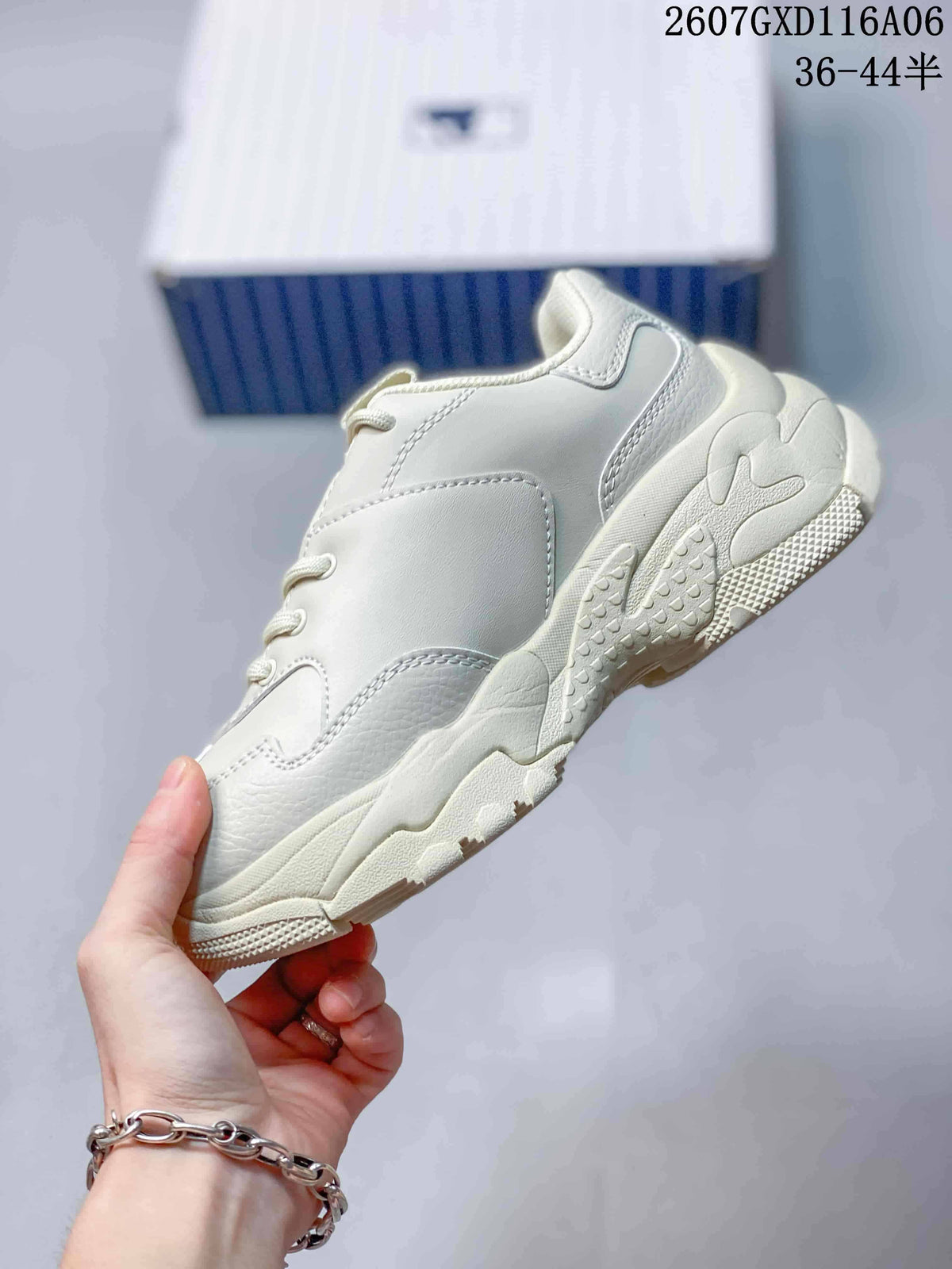 Side profile of the plain cream beige sneaker showing the layered chunky sole and stitched panels.
