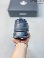 Rear view of the black sneaker showing the padded heel collar and outsole.