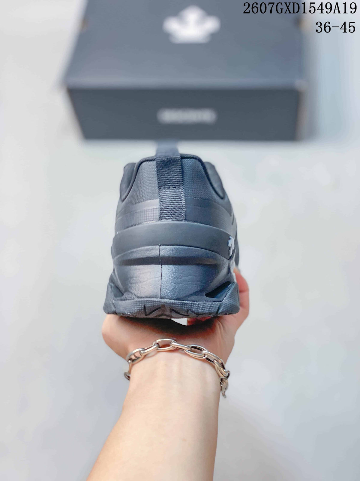 Rear view of the black sneaker showing the padded heel collar and outsole.