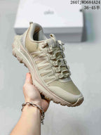 Three-quarter view of the beige-toned Alo sneaker showing the layered side panels, lace system, padded collar, and textured outsole.