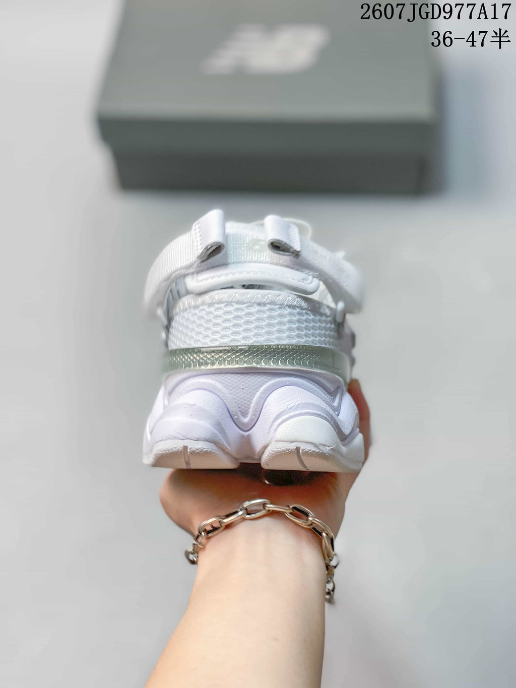 Rear view showing the padded heel area, heel strap construction, and sculpted white outsole.