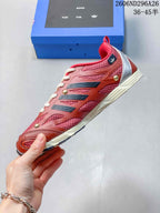 Side view of the red and silver low-top sneaker showing mesh panels, layered side details, metallic-colored accents, and the cream-toned midsole.