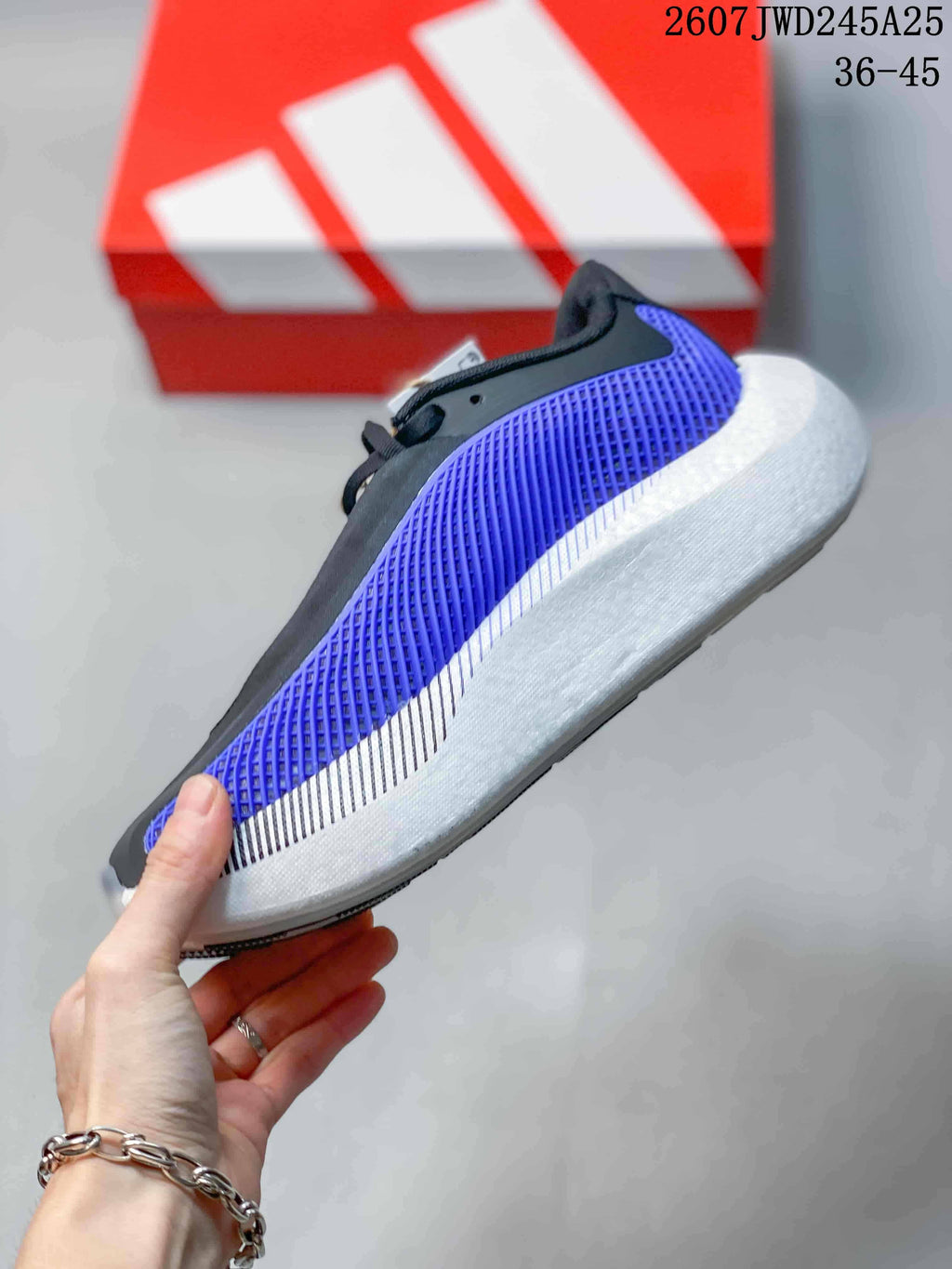 Side view highlighting the purple textured upper, black overlays and sculpted white midsole.