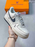 Close view of a white sneaker with patterned laces and dark side detailing