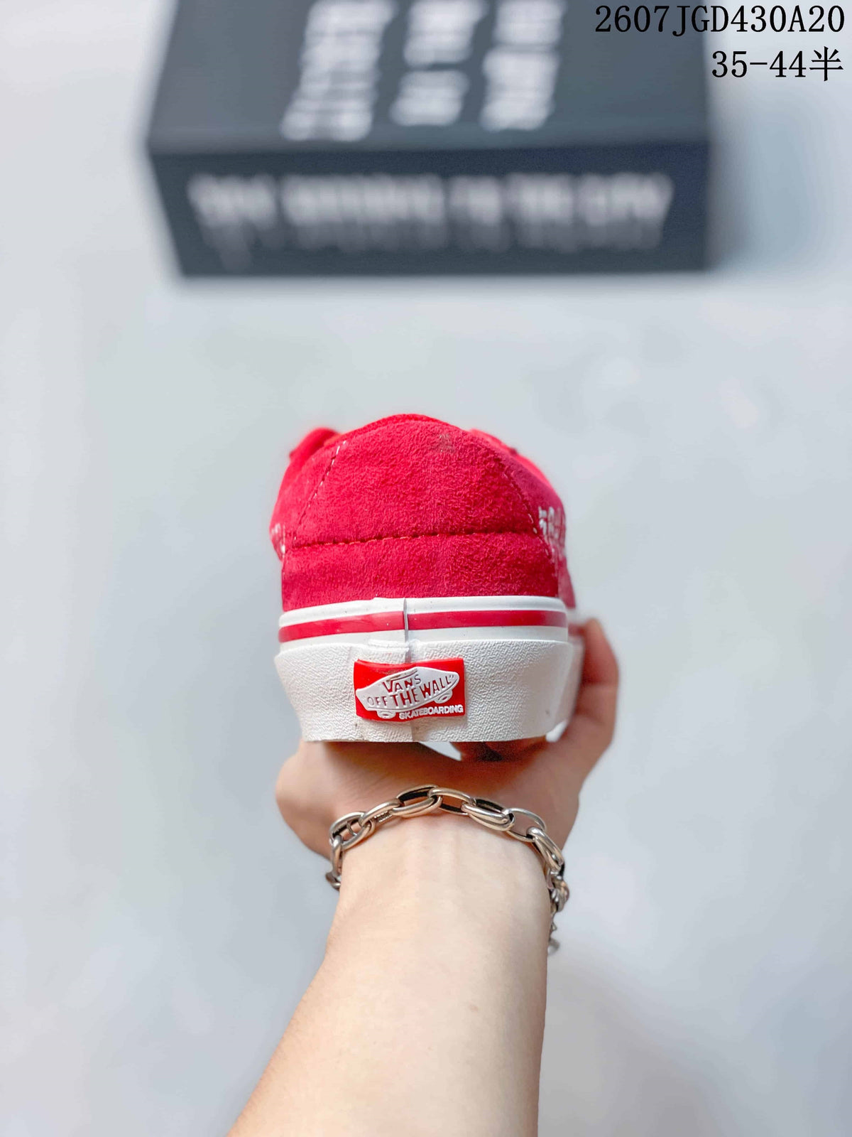 Rear view of the red sneaker showing the white-and-red sole trim and Vans Off The Wall heel label.