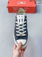 Top view showing white laces, metal eyelets, a white toe cap, and cross-shaped tongue detail.