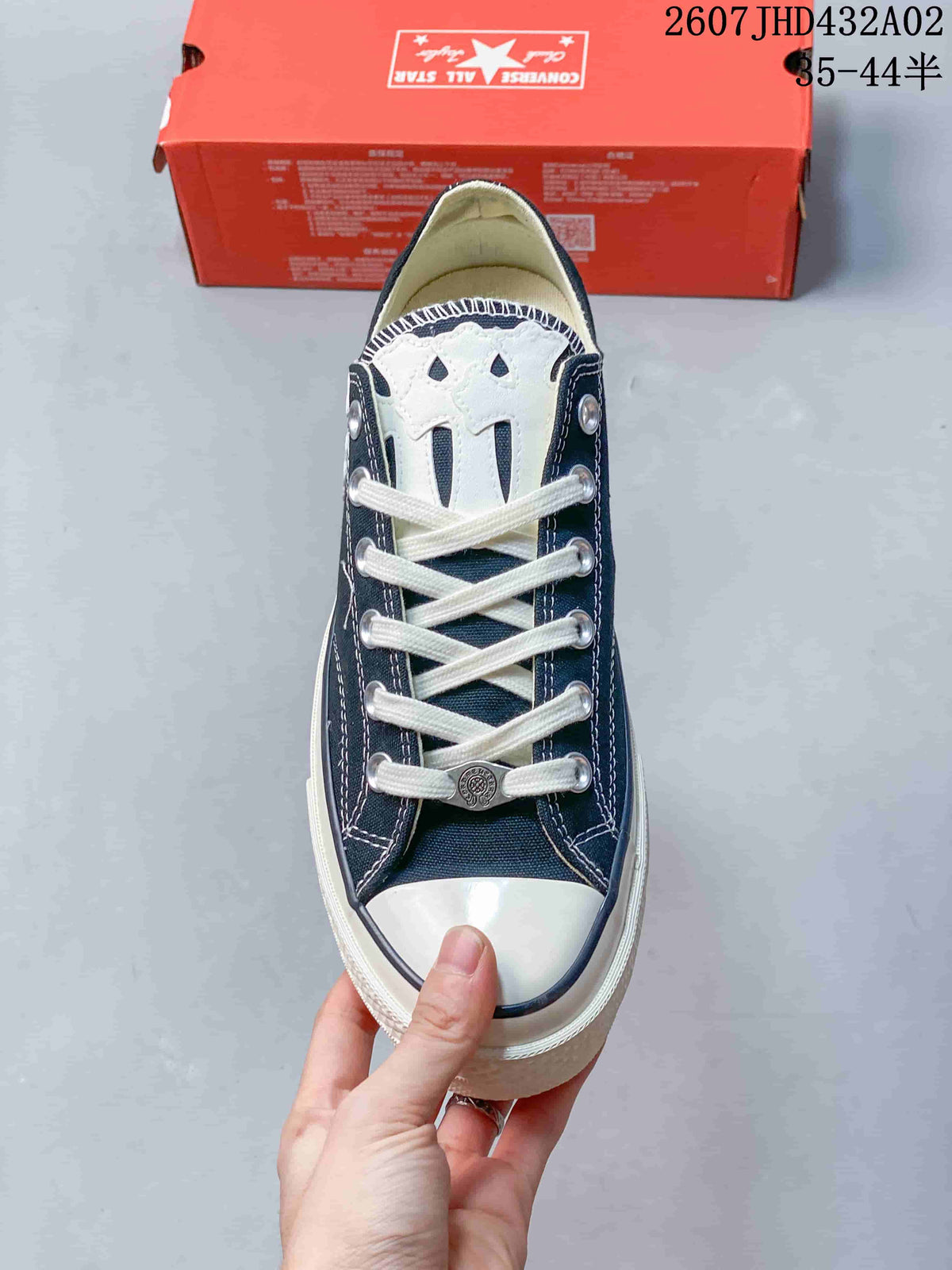 Top view showing white laces, metal eyelets, a white toe cap, and cross-shaped tongue detail.