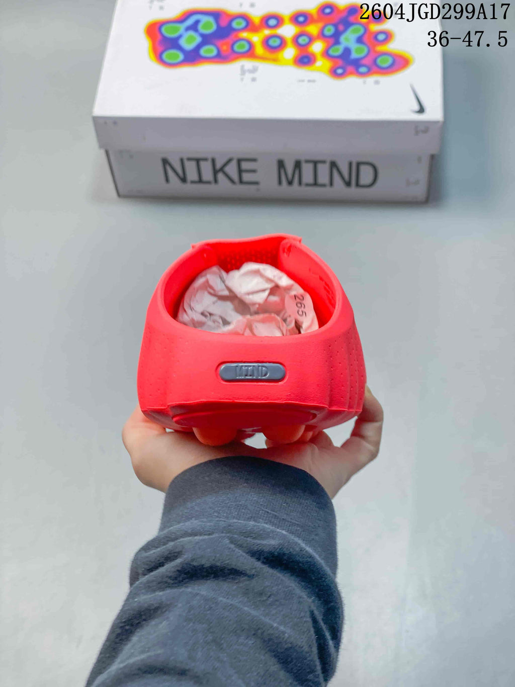 Rear view of a red Nike Mind slide showing the heel badge and perforated upper.