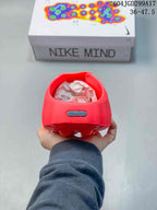 Rear view of a red Nike Mind slide showing the heel badge and perforated upper.