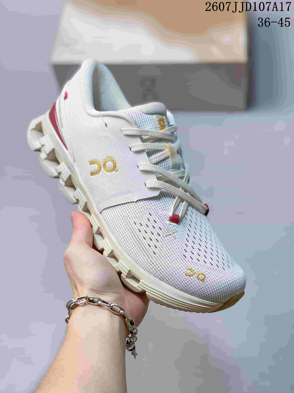 Angled side view of the white sneaker showing the knit-style upper, gold branding, and segmented outsole.