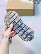 Underside of the sneaker showing its patterned gray and beige outsole