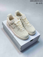 Pair of cream Nike Air Force 1 '07 LV8 low-top sneakers displayed on a shoebox.