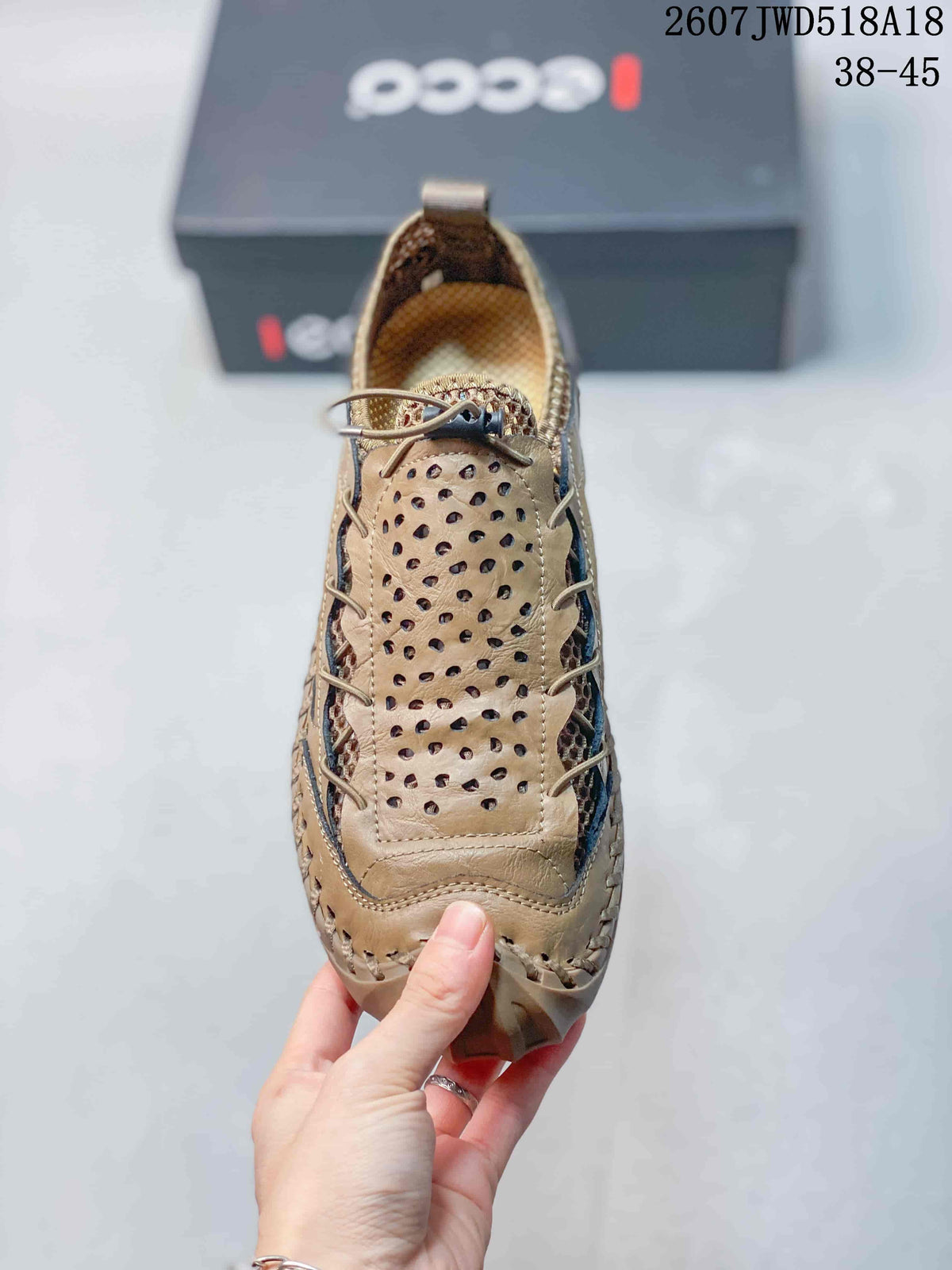 Top view of the tan sneaker showing the perforated tongue, laces and rounded toe.