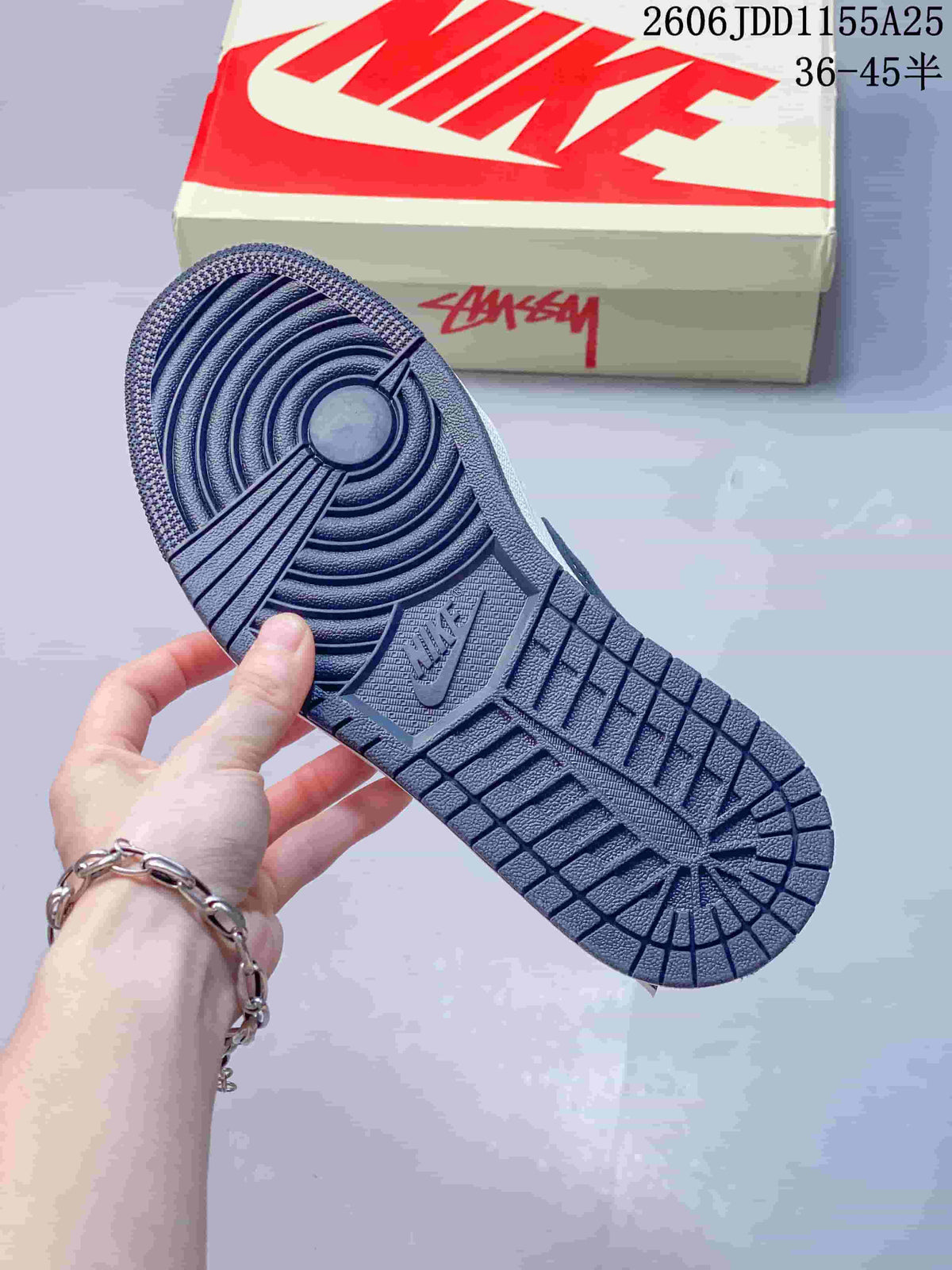 Close view of the textured navy outsole with circular traction grooves and segmented tread.